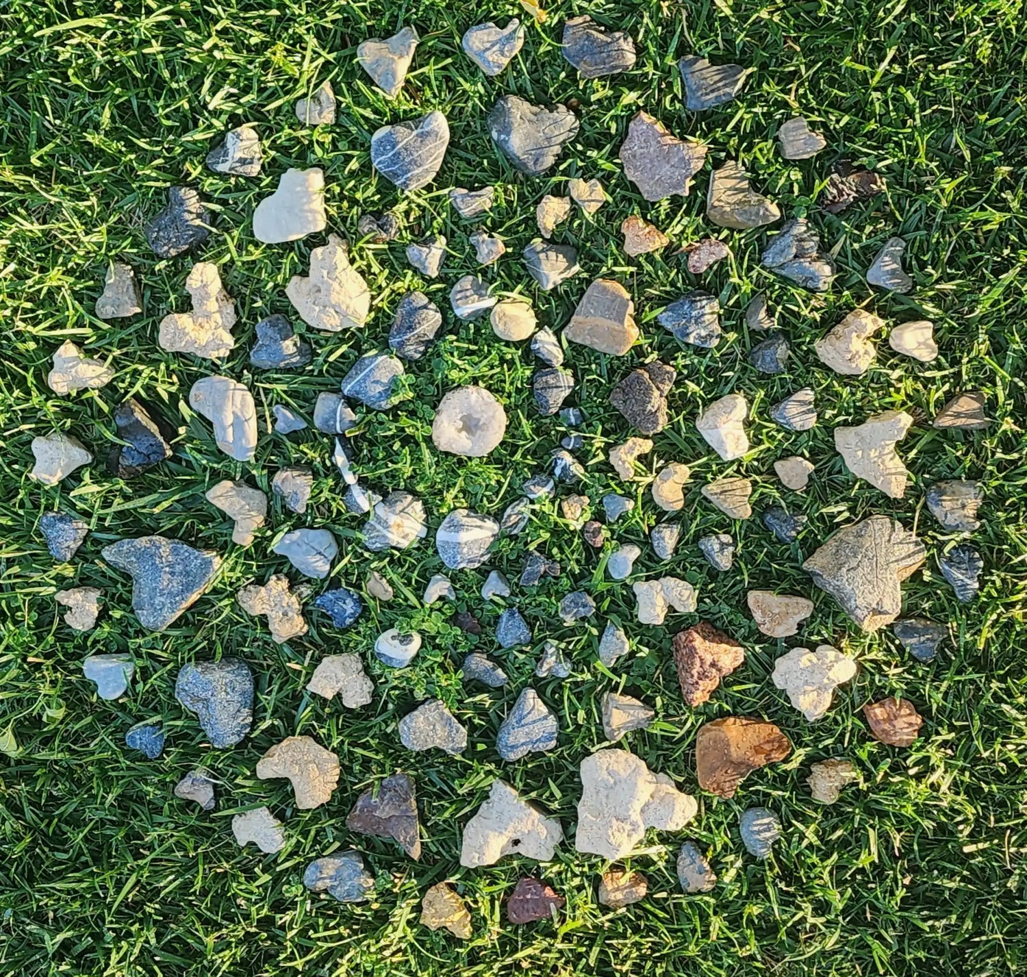 A collection of smooth, naturally shaped pebbles and stones in various colors and sizes.