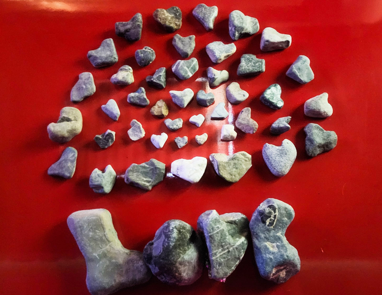 Heart shaped love rocks on a red background