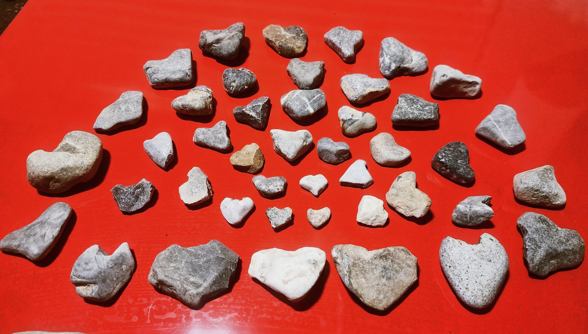 heart shaped love rocks on a red background