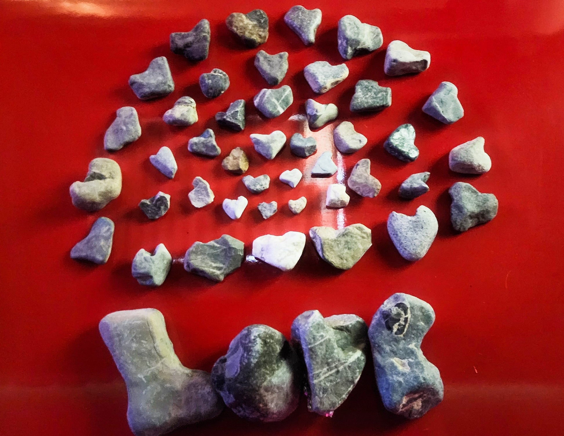 Heart shaped love rocks on a red background